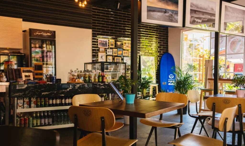 A cozy café with casual seating and a wall of framed photographs