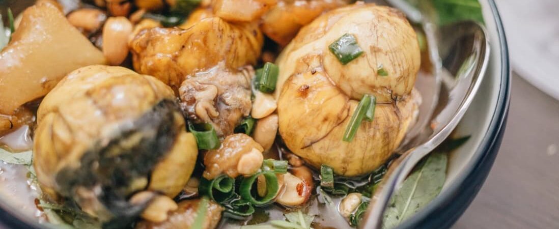 A traditional Asian dish with balloon-like mushrooms, nuts, and green onions in a bowl