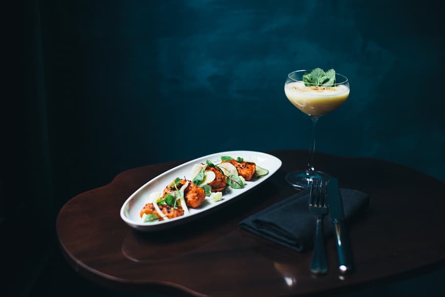 on the table, baked fish, cocktail, fork and knife