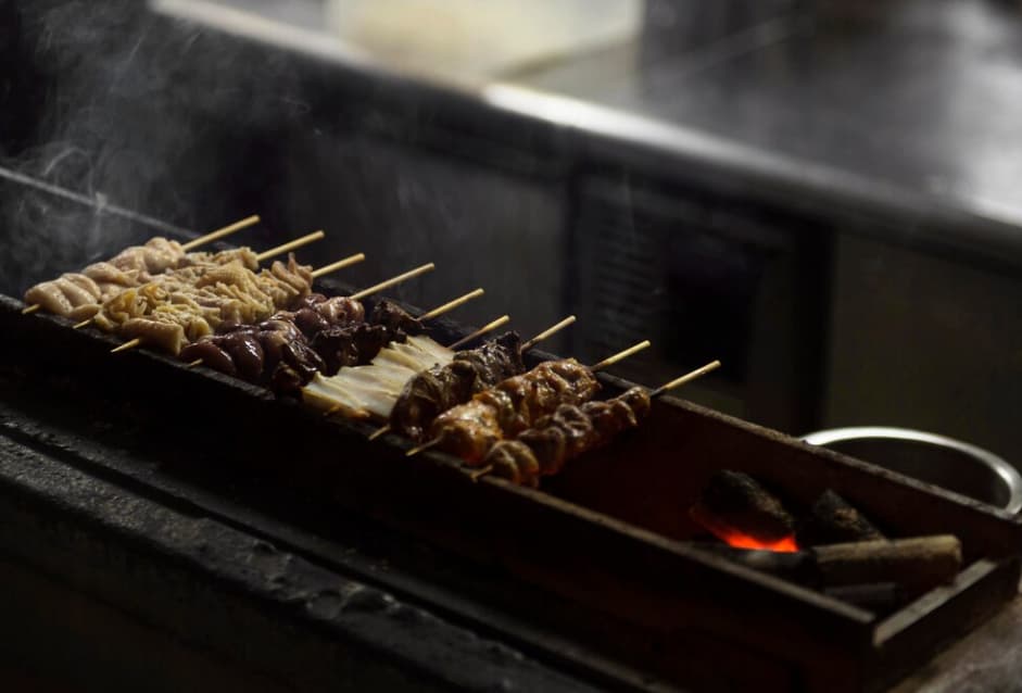 skewers with different types of meat on the grill in the kitchen