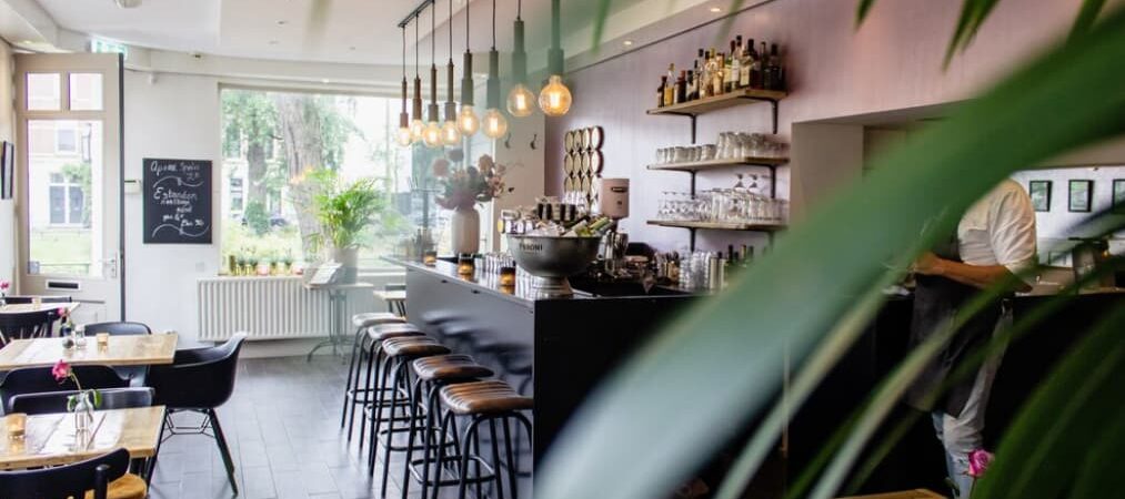 A cozy cafe interior with a bar and hanging lights