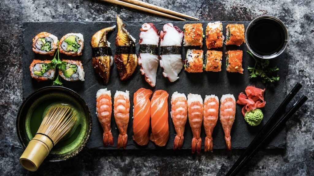 there's a board on the table with all the ingredients for sushi