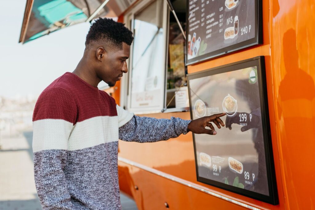 Man reading food truck menu