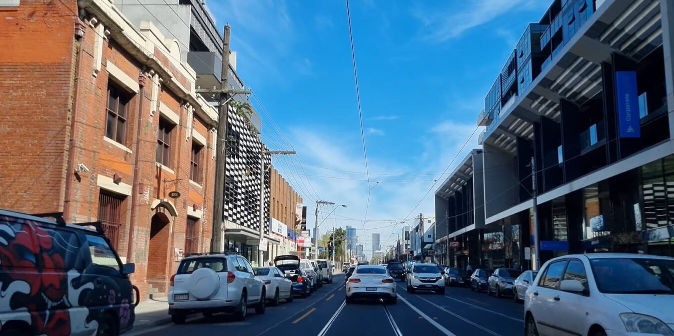 A sunny day on a busy city street with modern and historical buildings