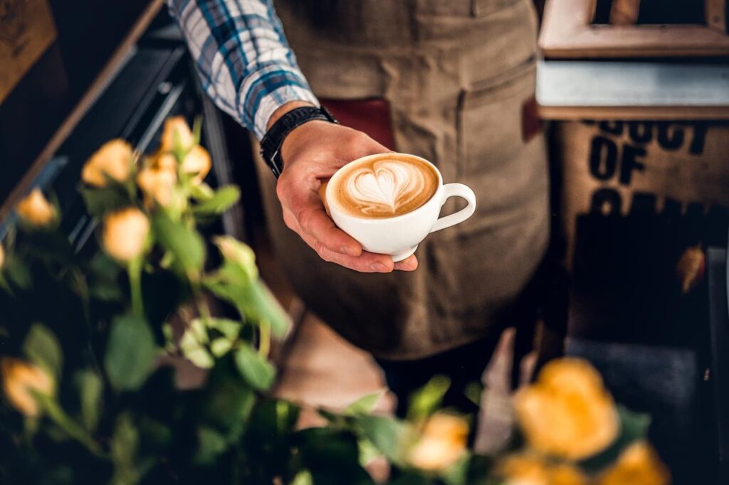 Man holding coffee from above